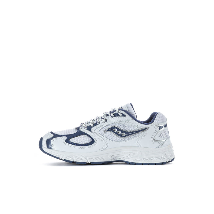 Kids lace-up running shoes in white with navy overlays and patterned outsoles