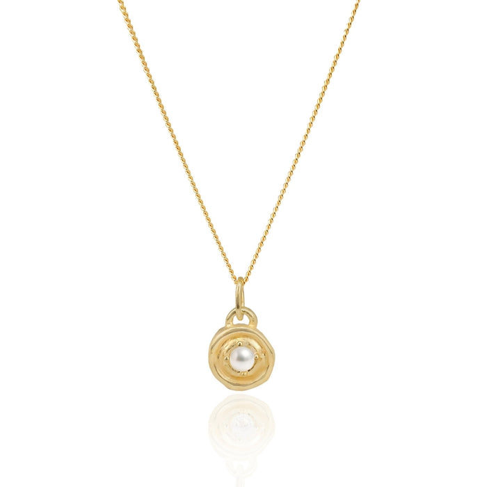Gold necklace with a black pendant on a white background