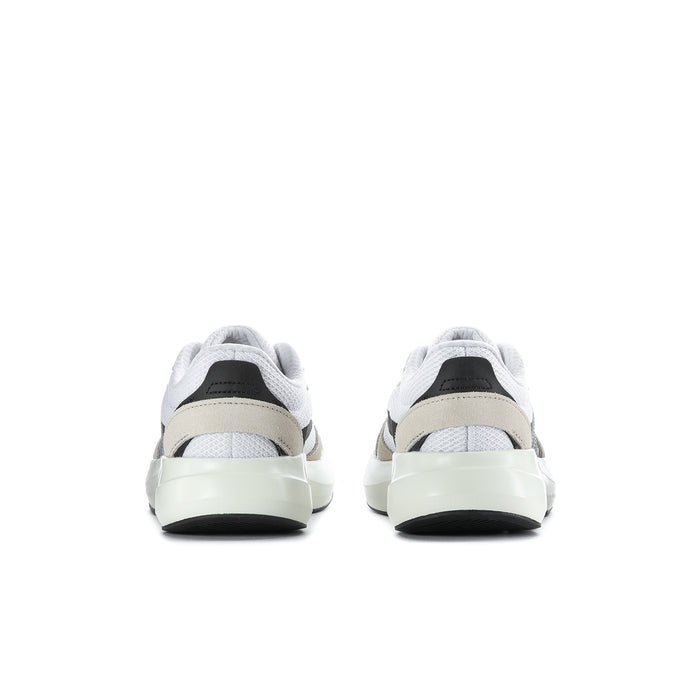 Women's sneakers heel view with white uppers, beige collar, black heel tab, cushioned sole