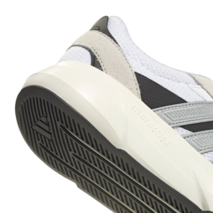Close-up of women's sneaker with beige overlay, white upper, and black outsole tread