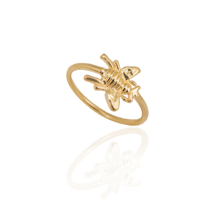 Gold ring with a unique design on a white background
