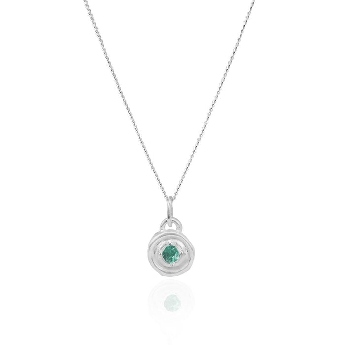 Silver necklace with a green gemstone pendant on a white background