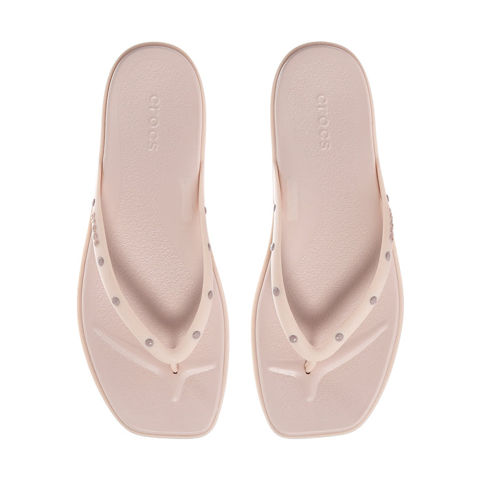 Women's light pink flip-flops with studded thong straps and smooth footbed
