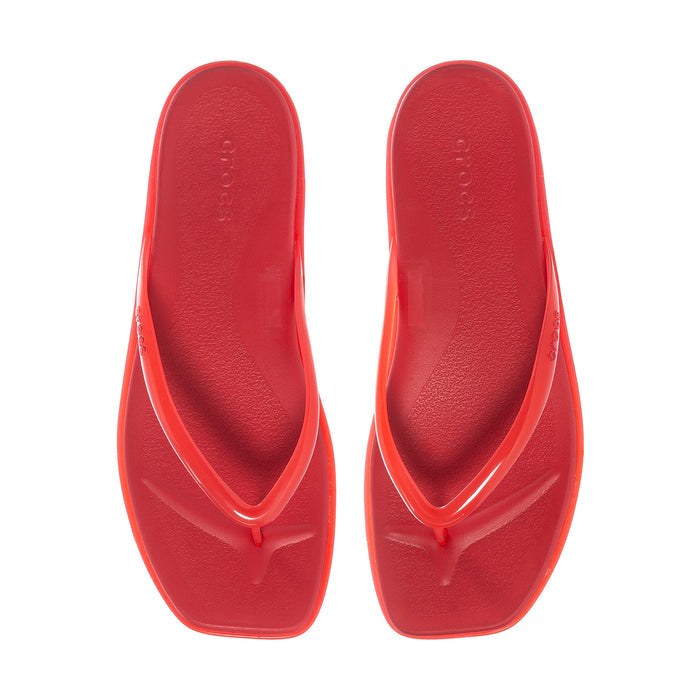 Red jelly thong sandals, showing two flip-flops with embossed logo on footbed