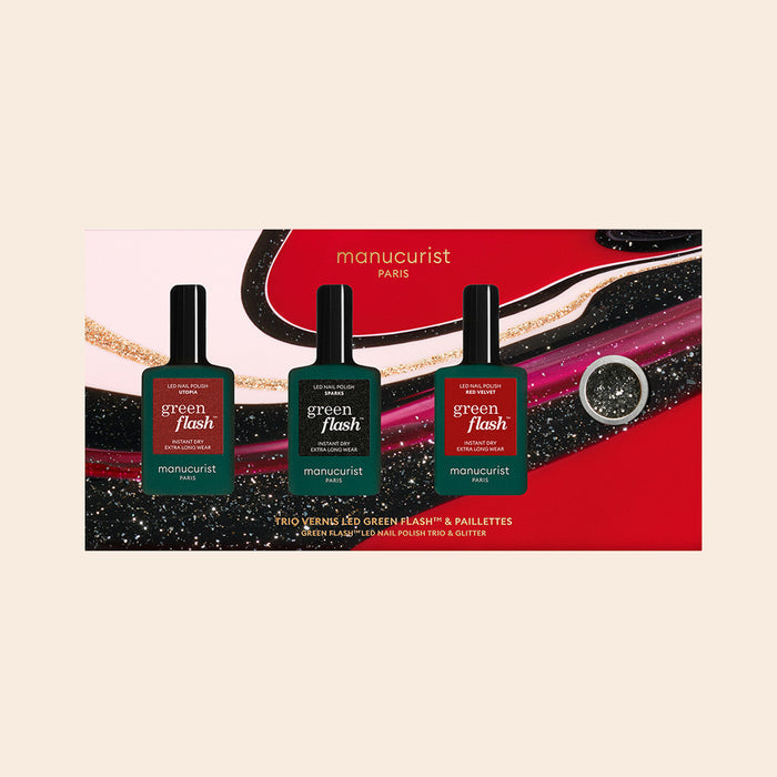 The Manucurist-test Midnight Glam Trio + Glitter Set features three Green Flash nail polishes in a colorful gift box with abstract swirl designs and biodegradable glitter.