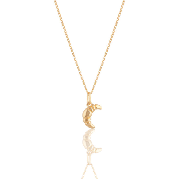 Mini Croissant Necklace in Gold from the ACME x Luna & Rose collection, a dainty croissant-shaped pendant for an elegant and playful touch.