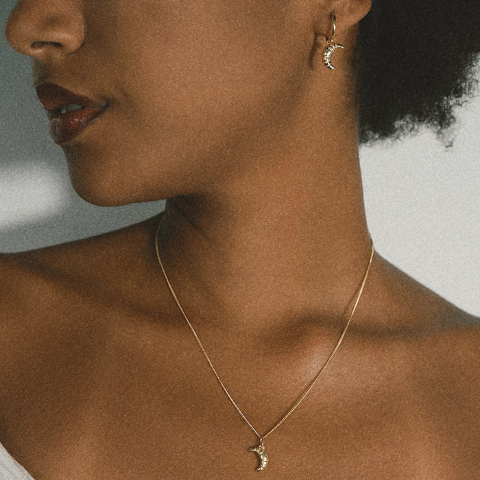 Mini Croissant Necklace in Silver from the ACME x Luna & Rose collection, a delicate croissant-shaped pendant perfect for layering or wearing solo.
