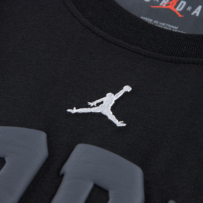 Youth black T-shirt with small white Jumpman logo near chest