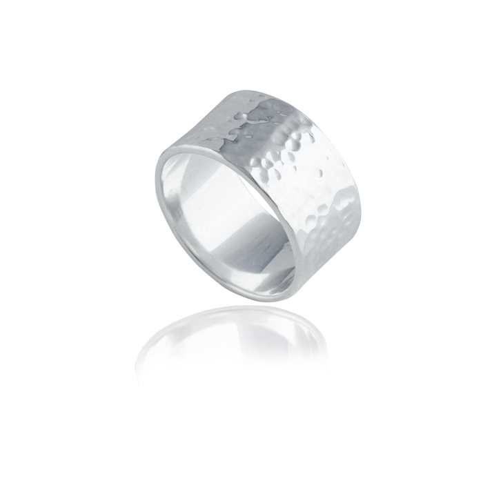 A silver hammered ring isolated on a white background with a reflection.