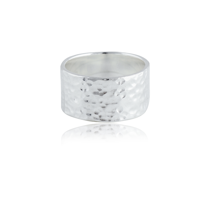 A wide silver hammered ring isolated on a white background with a reflection.