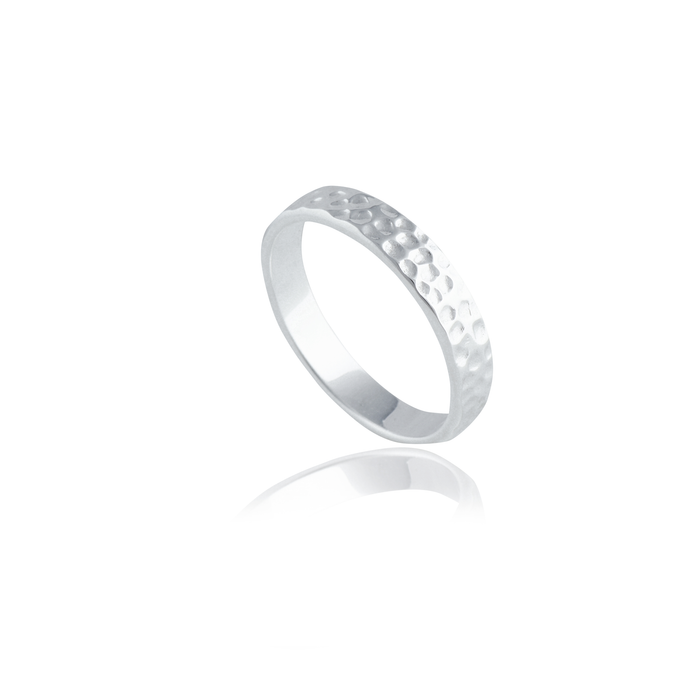 A silver hammered ring isolated on a white background with a reflection.