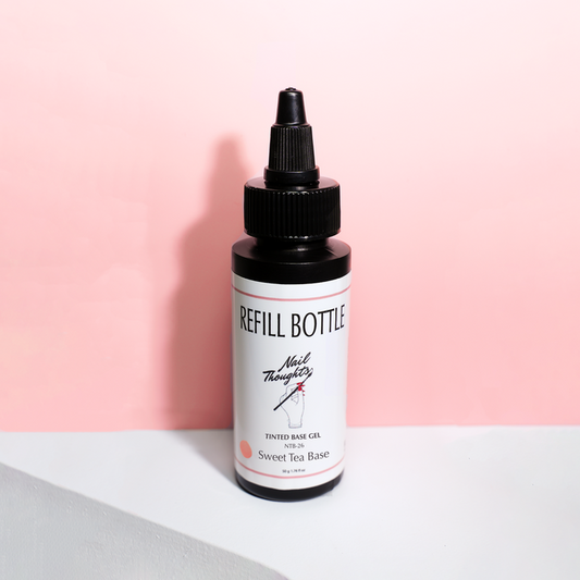 A bottle labeled 'Sweet Tea Base' with a dropper, placed against a pink background.