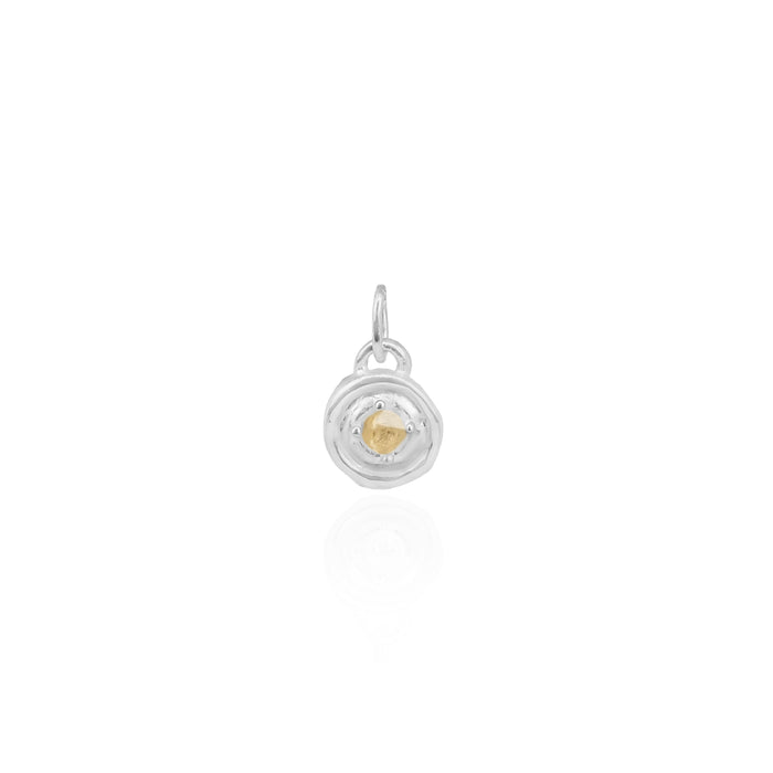 Silver pendant with a yellow gemstone on a white background