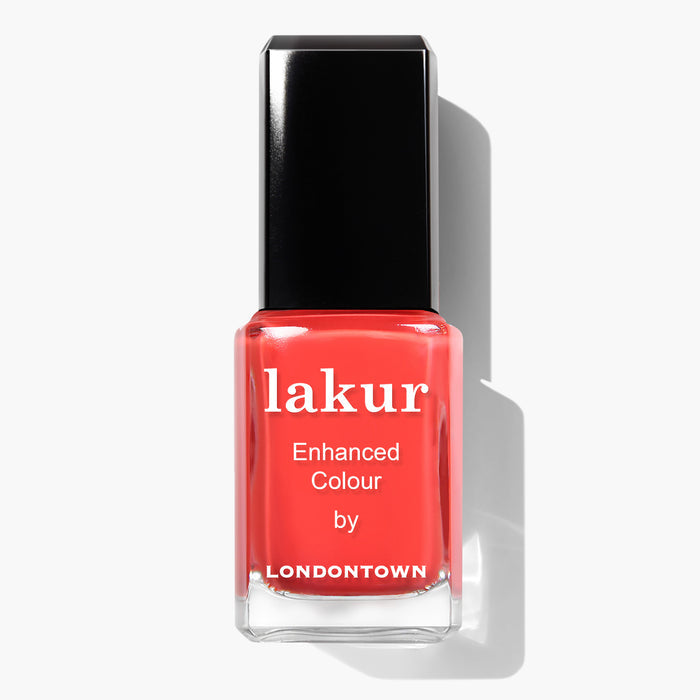A bottle of Piccadilly Square nail polish by LONDONTOWN, featuring an ultra-bright blood orange crème color with a black cap, on a white background. This vegan and cruelty-free nail polish delivers both style and conscience.