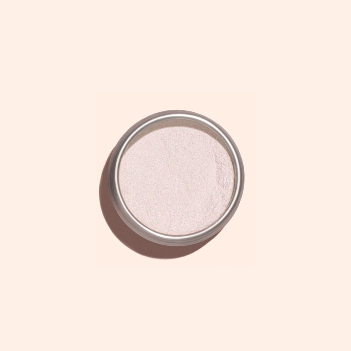 A round metal container of Manucurist Pink Glazed Effect Powder, featuring a subtle pearlescent sheen, is viewed from above against a light beige background.