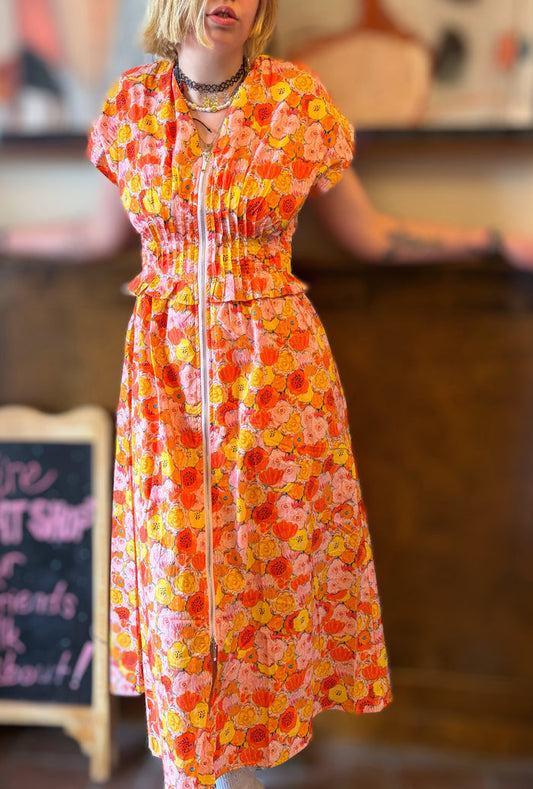 Entro Poppies Dress displayed flat with floral pattern, showcasing vibrant colors and elegant design.