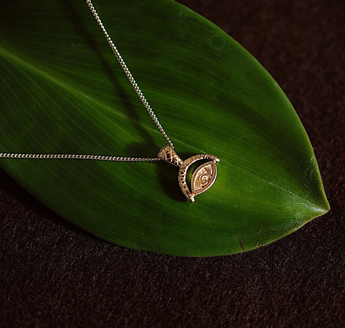 Protection Evil Eye Necklace -  Gold on green leaf