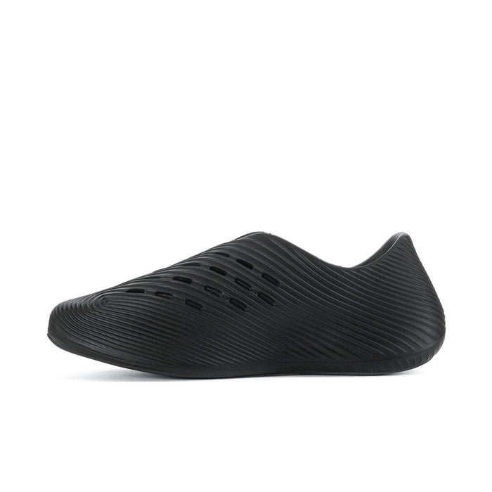 Men's slip-on sport shoe, dark black side view with perforated toe and ribs