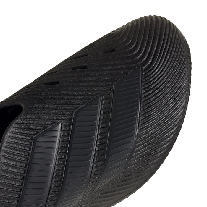 Men's slip-on sport shoe side close-up, dark black ribbed texture and stripes