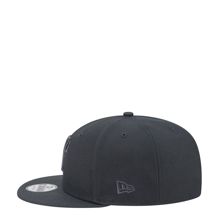 Dark gray baseball cap with small tonal emblem patch at side