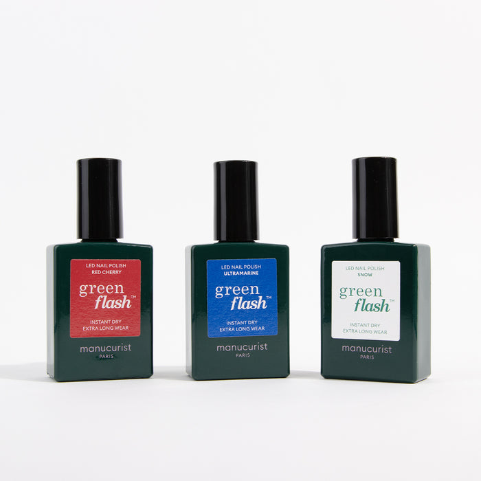 Three bottles from the Manucurist Red, White  Blue Trio nail polish set stand side by side on a white background, each featuring vibrant red, white, and blue shades.