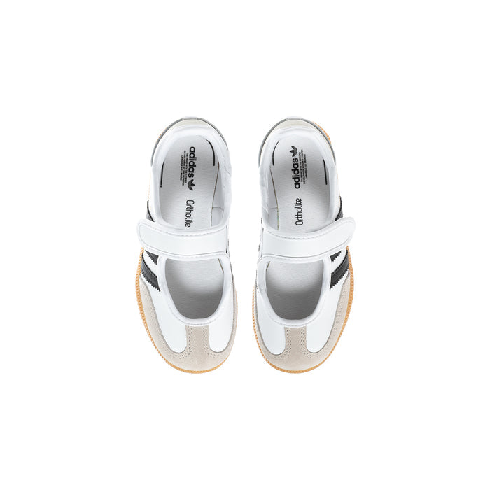 Kids white sneakers with black stripes and gum detailing at the heel and toe