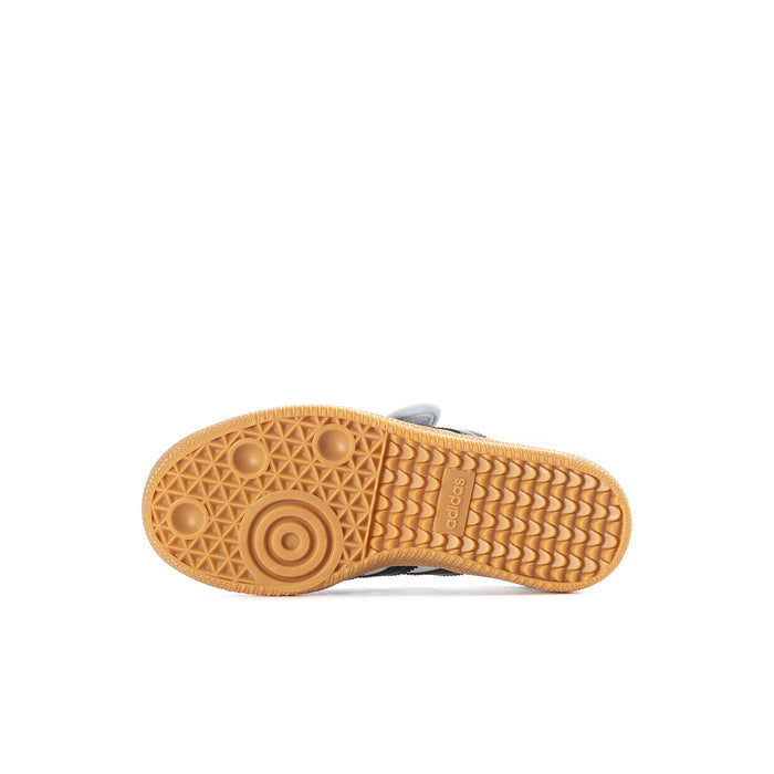Kids sneaker outsole with textured gum rubber tread and circular grip pads