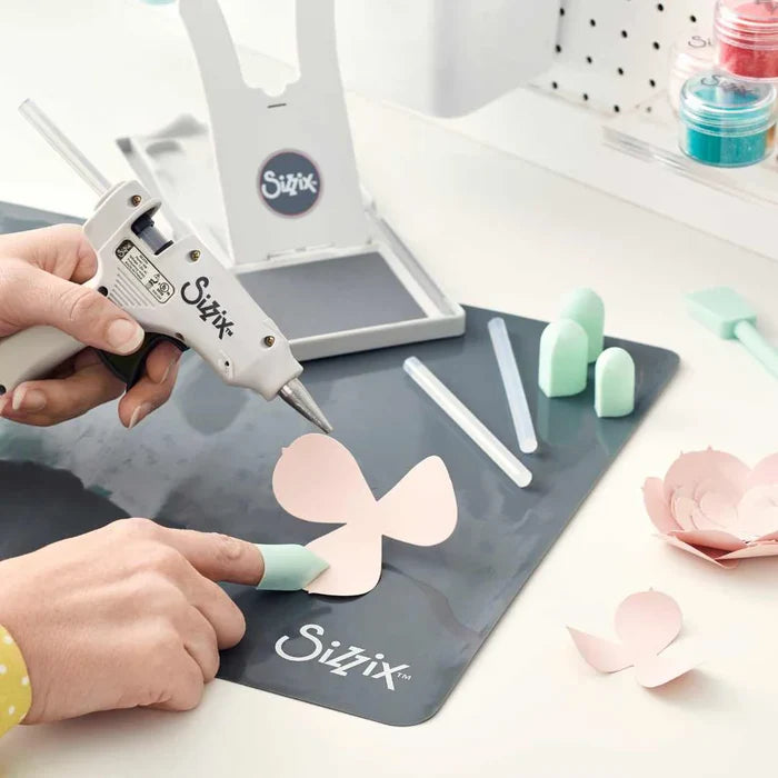 Sizzix - Glue Gun. Forget the mess! The Sizzix Glue Gun was designed to bond and adhere materials on a variety of surfaces for plenty of good clean fun. Available at Embellish Away located in Bowmanville Ontario Canada.