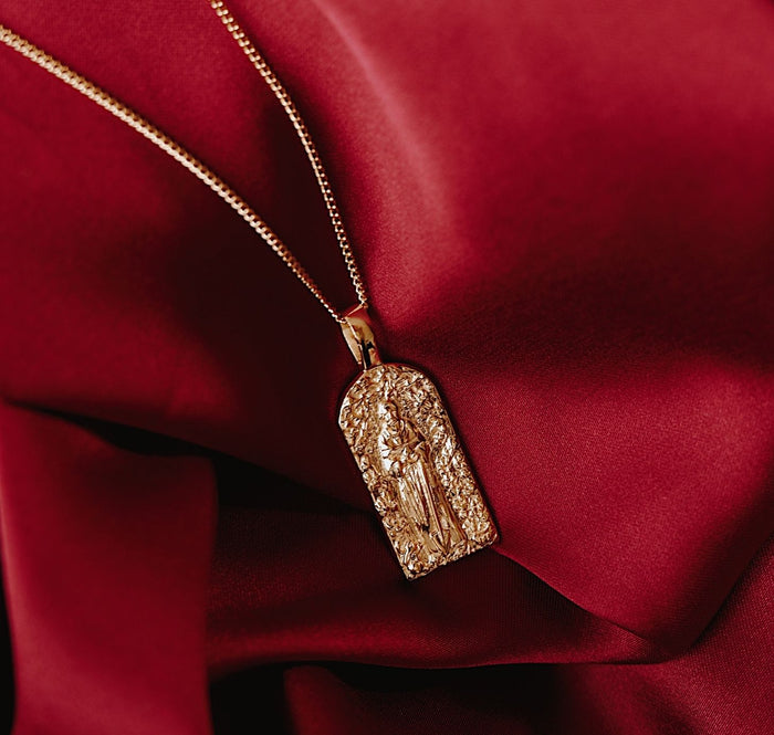 St Fiacre - Patron Saint of Gardening - CHARM ONLY - Gold flat lay in red fabric