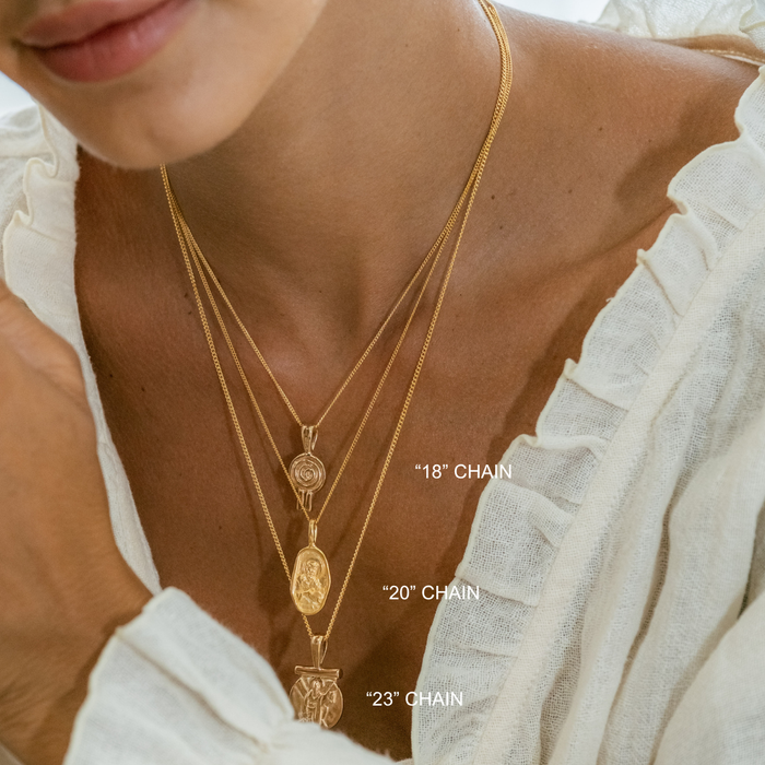 Close-up of a person wearing gold necklaces with chain lengths labeled.
