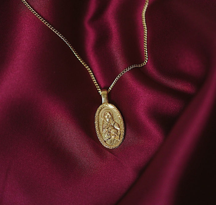 St Melangell - Patron Saint of Small Animals - gold flat lay in red fabric