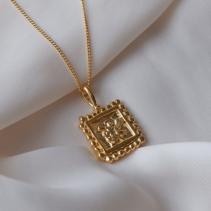 St Michael - Patron Saint of Protection & Overcoming Challenges flat lay in white fabric