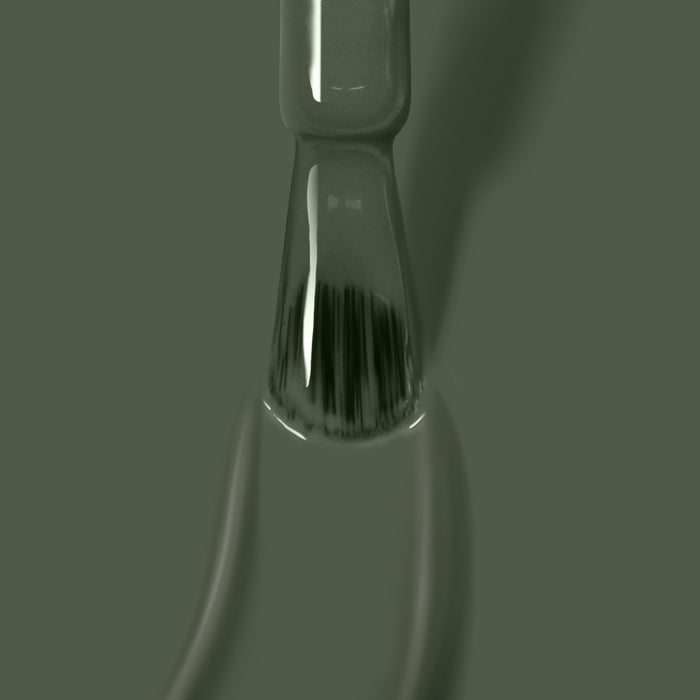 Close-up of a Star Moss vegan cruelty-free green glass laboratory pipette by LONDONTOWN, filled with liquid and casting a shadow against a similarly colored background.