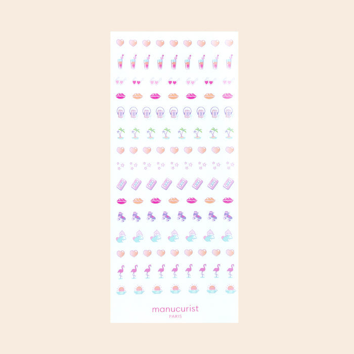 Stick on vibrant designs like sunglasses, lips, flamingos, pineapples, palm trees, shells, and cocktails with Stickers Nail Art Pink Addict by Manucurist-test—perfect with your favorite gel polish. "manucurist PARIS" appears at the bottom.
