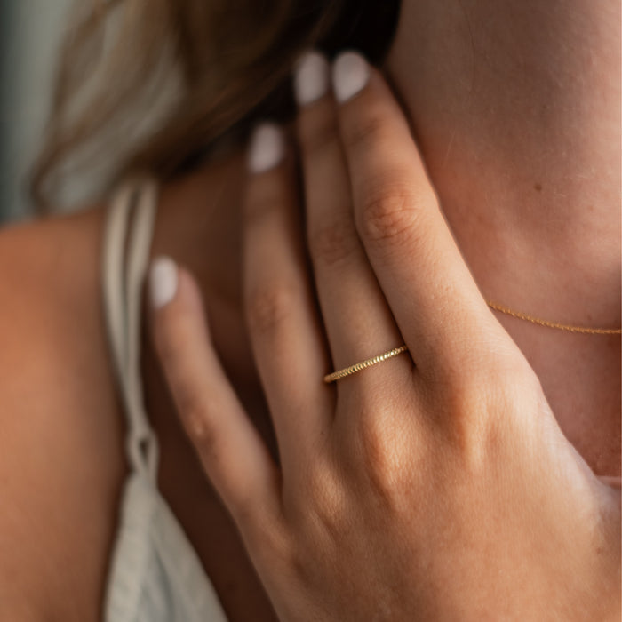 The MET Stripe Band - Gold on woman finger