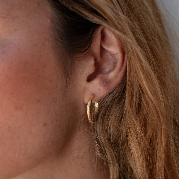 The MET Stripe Thin Earrings 18mm - Gold worn  by a woman