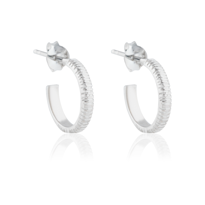 The Met stripe hoops earrings silver on white background and it reflection