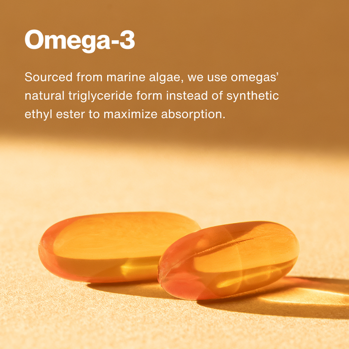 Two orange gel capsules on sand with tan background and text about omega-3 sourcing.