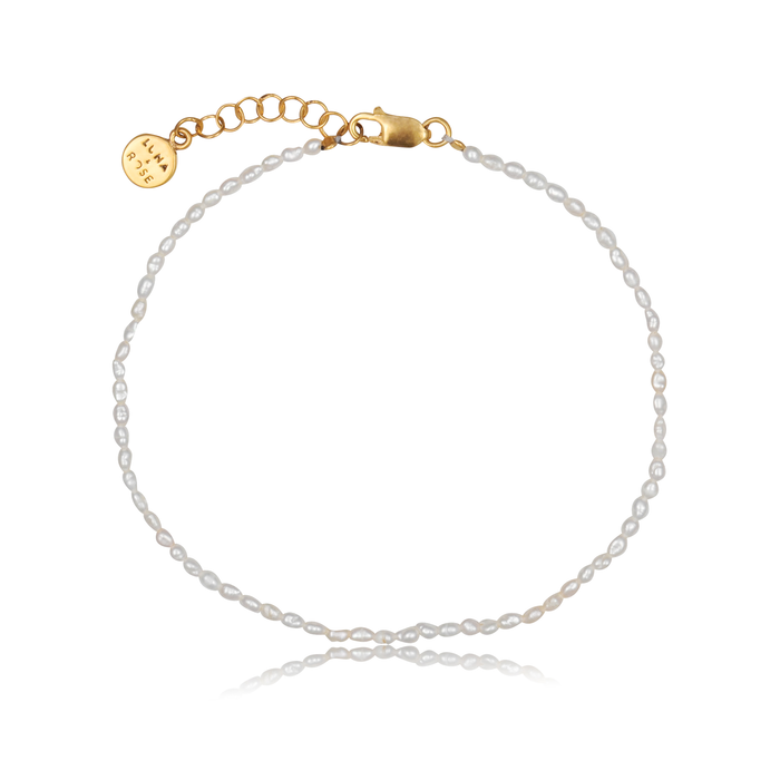 a piece of The Timeless pearl anklet gold on white background