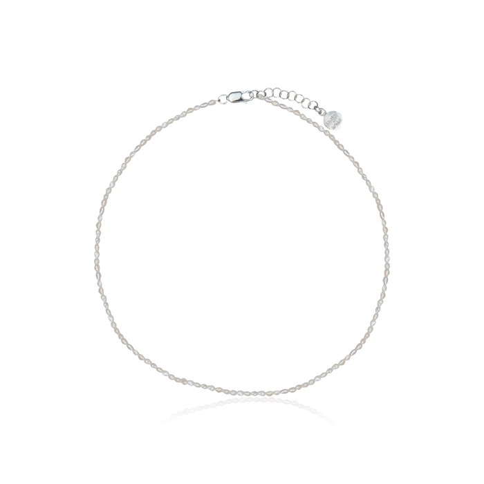 a piece of silver necklace with pearl white and claps