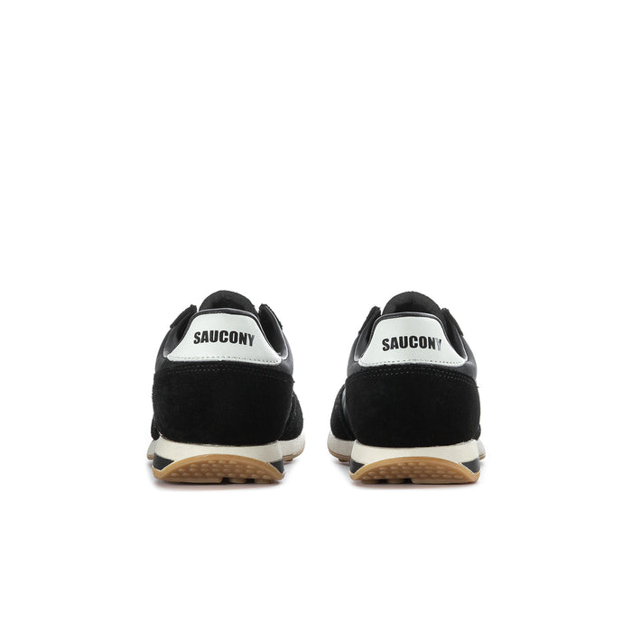 Youth black sneaker back view with white heel label and gum sole