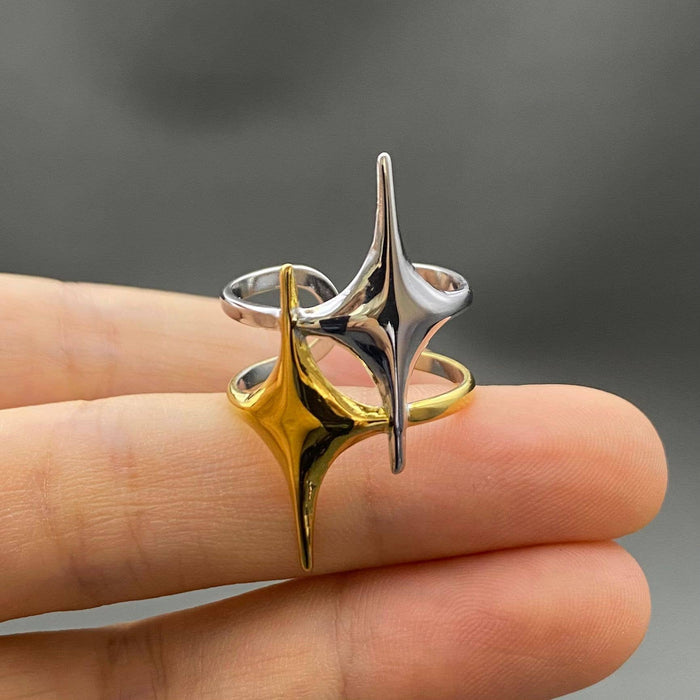 Two-tone double star ring by Mio Queena, featuring layered silver and gold-tone design with star motifs, on a white background.