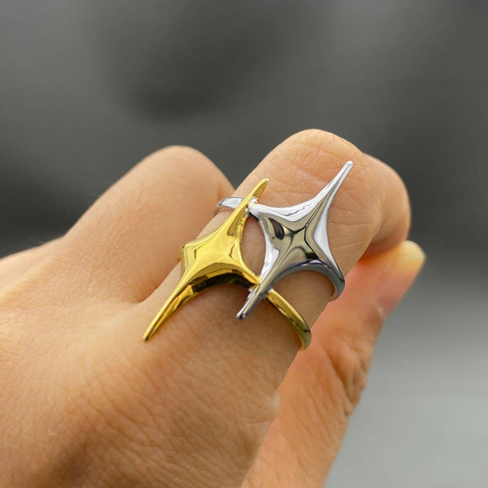 Two-tone double star ring by Mio Queena featuring layered silver and gold-tone stars on a sleek band.