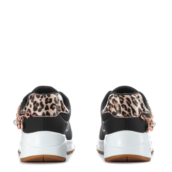 Kids black low-top sneakers back view with leopard heel panels and rose-gold charm chain