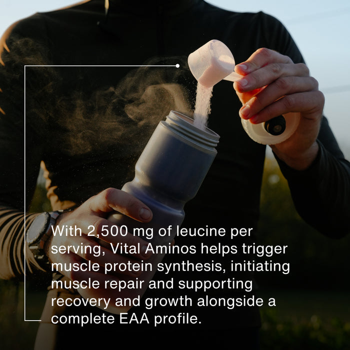 Person pouring powder into a water bottle outdoors. Text reads: “With 2,500 mg of leucine per serving, Vital Aminos helps trigger muscle protein synthesis, initiating muscle repair and supporting recovery and growth alongside a complete EAA profile.”