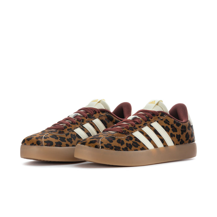 Pair of leopard print low-top sneakers with cream side stripes and burgundy laces