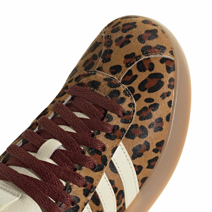 Leopard print sneaker upper close-up with burgundy lace detail and cream trim