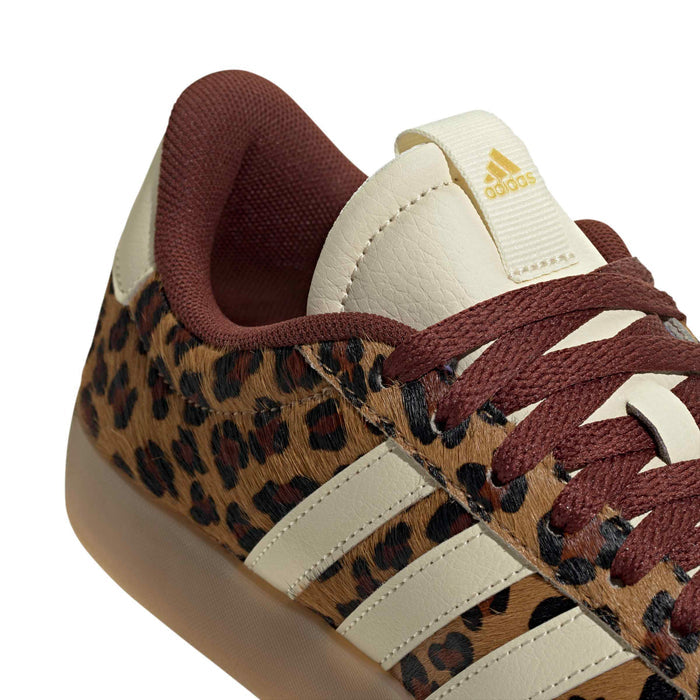 Leopard print sneaker close-up with cream stripes, burgundy laces, and gum sole edge