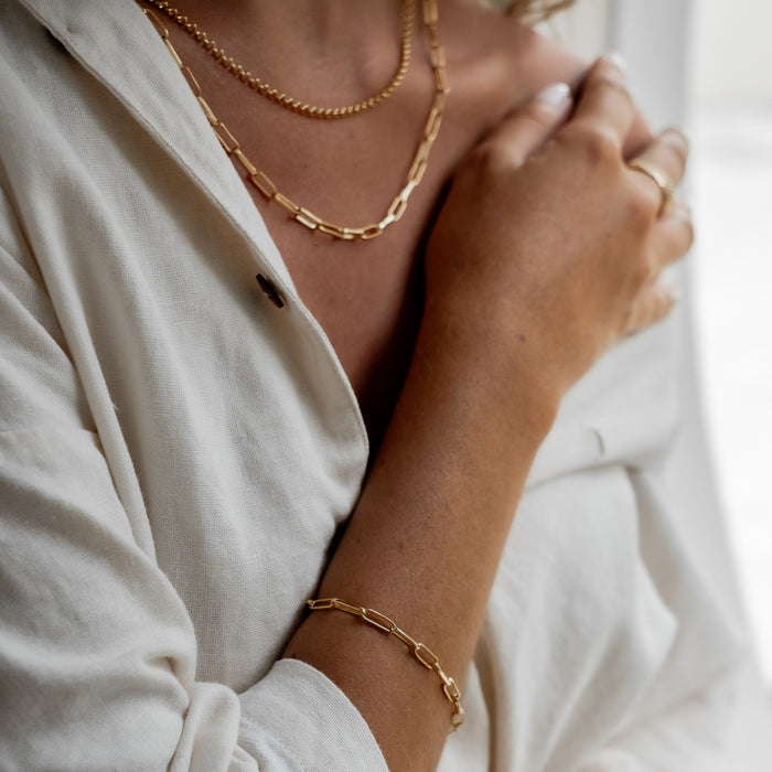 a woman wearing Washington Paper Clip Bracelet - Gold and two necklaces gold