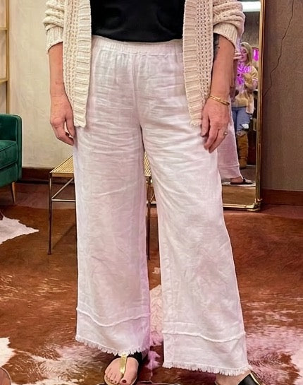 White linen pants by Camille & Co. featuring a relaxed fit, comfortable waistband, and lightweight fabric for casual wear.